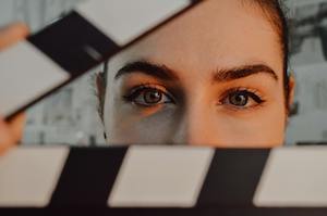 Woman holding a clapperboard